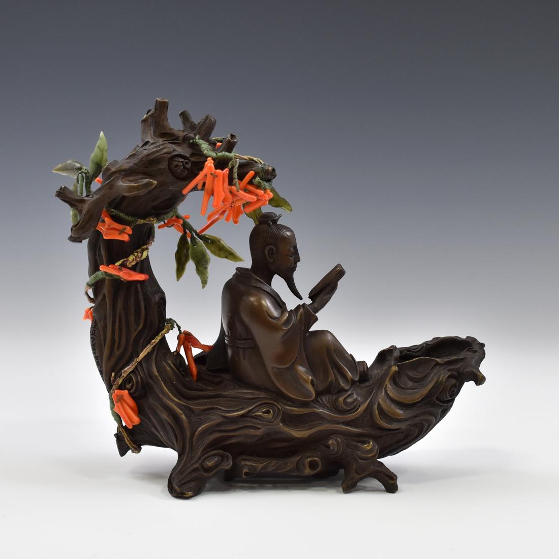BRONZE & RED CORAL SCHOLLAR BENEATH TREE FIGURE: Fine carved by hand craftsman Chinese bronze of seated peaceful scholar elder reading a poem, with seated slightly backward with knee bended in relaxing position, in the comfortable old oak seat and s