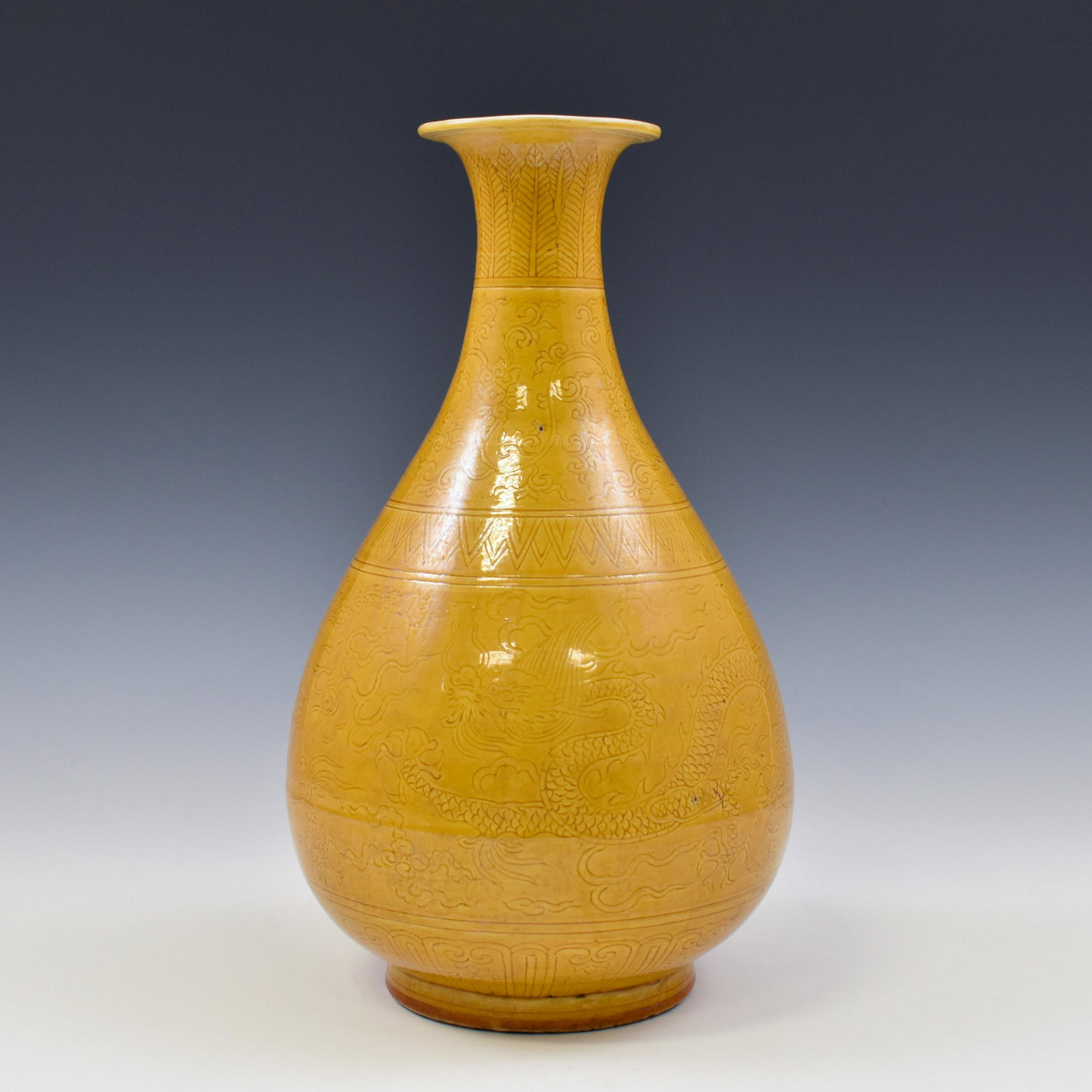MING JIAJING FAMILLE JAUNE DRAGON SGRAFITTO PEAR VASE: Chinese Ming Dynasty Period, Jiajing famille jaune dragon sgrafitto motif porcelain pear vase. The porcelain potted in Chinese traditional YuHuChun shape vessel, the pear shaped bottle vase, slight ov