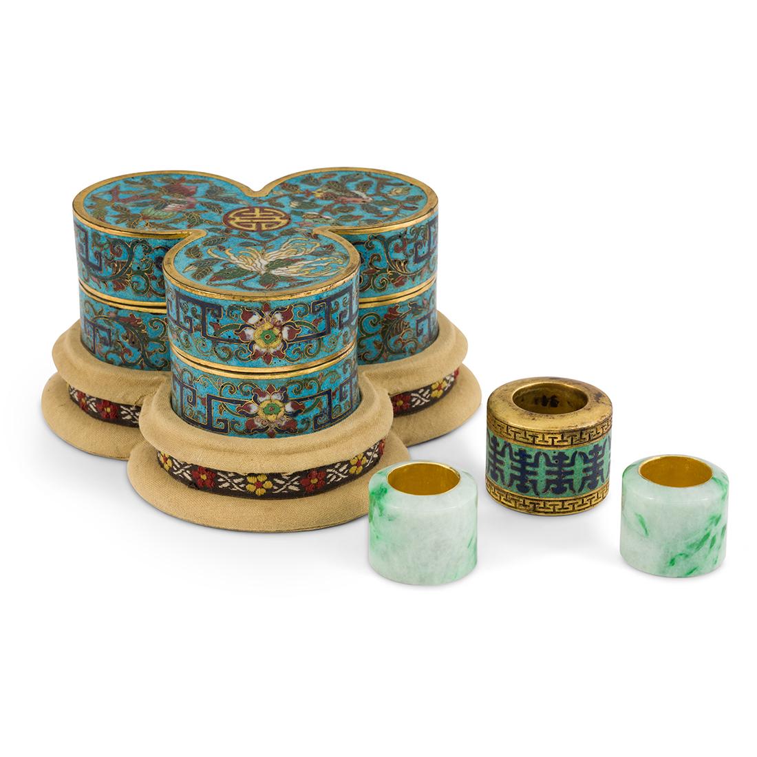 SET 3 ARCHER RINGS & CLOISONNE BOX: A fine Chinese Qing Dynasty gilt bronze cloisonne box with three archers rings. Three archery rings each having different ring size. Consist of two jadeite archers rings, and one gilt bronze cloisonne