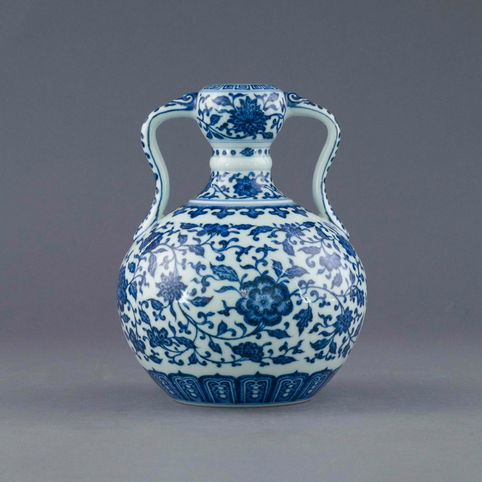 YONGZHENG BLUE & WHITE WRAPPED FLORAL AMPHORA VASE: Dimensions: 8.375in H x 6.25in W x 6.25in D Chinese Qing Dynasty Period, Yongzheng blue & white wrapped floral amphora vase. The porcelain potted in the amphora vase, thick, stout main belly, rim, tap