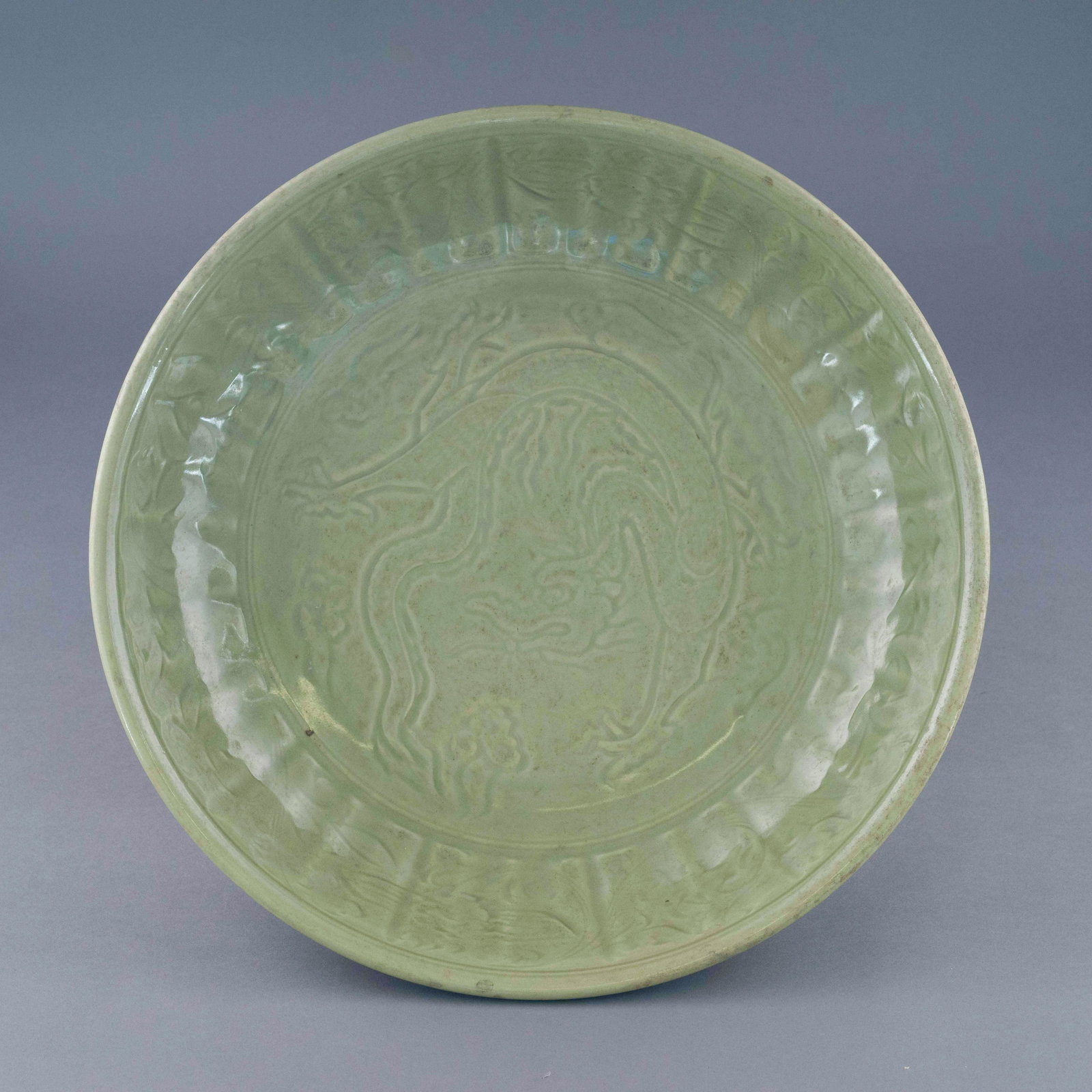 EARLY MING SGRAFITTO DRAGON LOBBED RIM CHARGER: Dimensions: 4.14 H x 18.5in W Chinese Early Ming Dynasty Period, Hongwu a dragon pattern sgraffito celadon plate. The Porcelain potted in shallow vessel form, with broad wide central interior, rounded