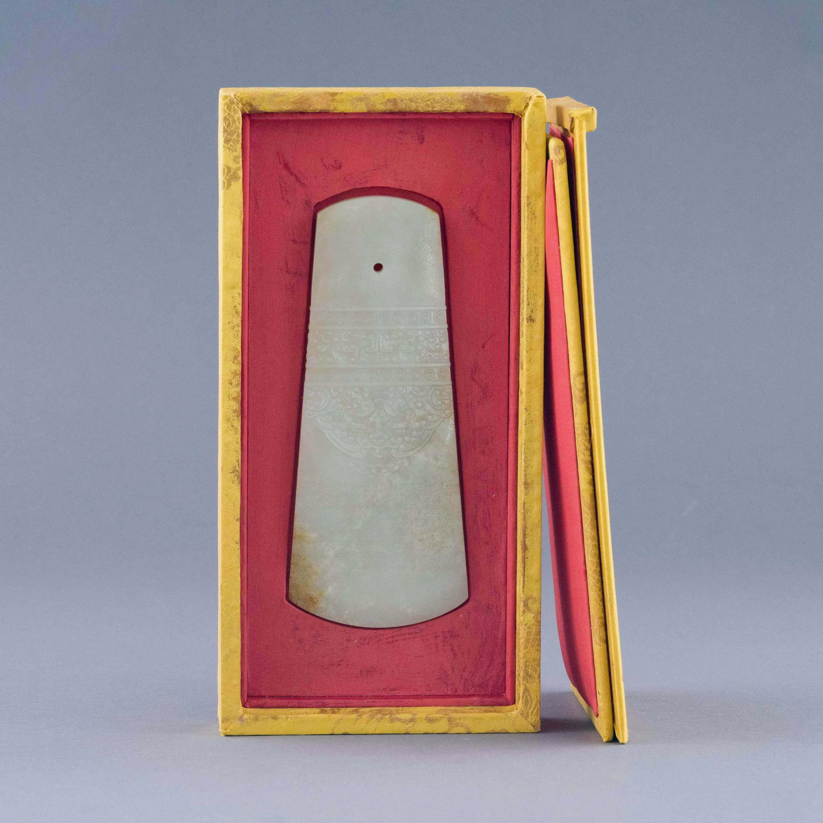 ANTIQUE JADE CARVED CEREMONIAL AXE: Dimensions: 1.375in H x 5.125in W x 10.25in D Chinese HongShan culture period antique jade carved ceremonial axe. The nephrite jade carved in rectangles, with bigger in sharp side, thick opening pit o