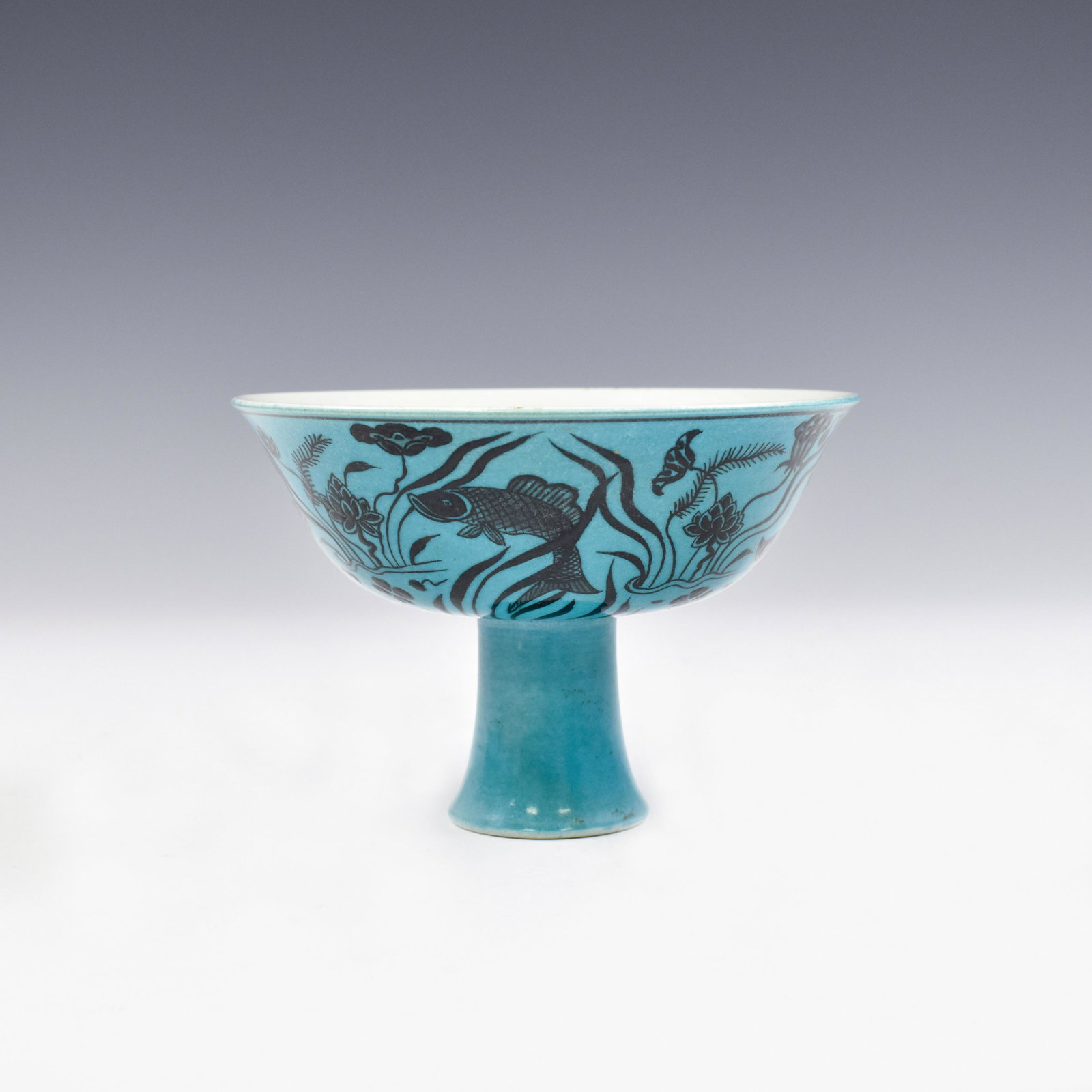 MING BLACK AND PEACOCK BLUE STEM BOWL: Dimensions: 3-7/8" H x 5-7/8" Diam. Fabulous, Chinese Ming Dynasty Xuande Period, Black and Peacock Blue High Porcelain Cup. All reserved hand painted ornamentations are rendered in pale blue undergla