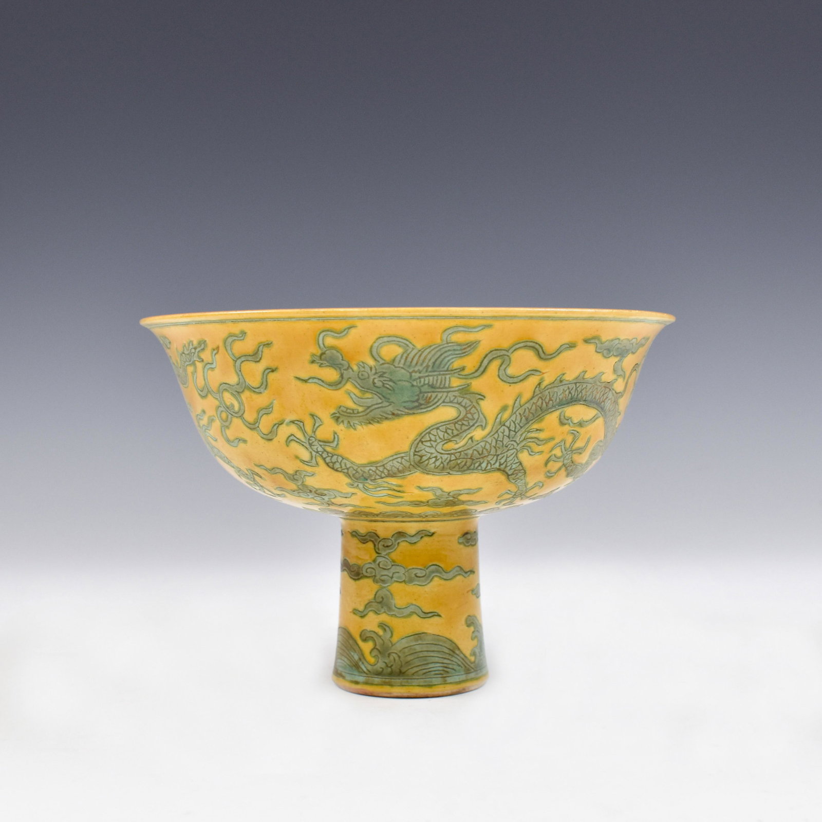 MING JIAJING GREEN DRAGON ON YELLOW HIGH BOWL: Dimensions: 4-7/8" H x 6-7/8" Dia. Lustrous, Chinese 15th C. Ming Dynasty Jiajing Reign Period, famille jaune Imperial Dragon high bowl. Deep curvature, of a shallow vessel, round straight upward to f