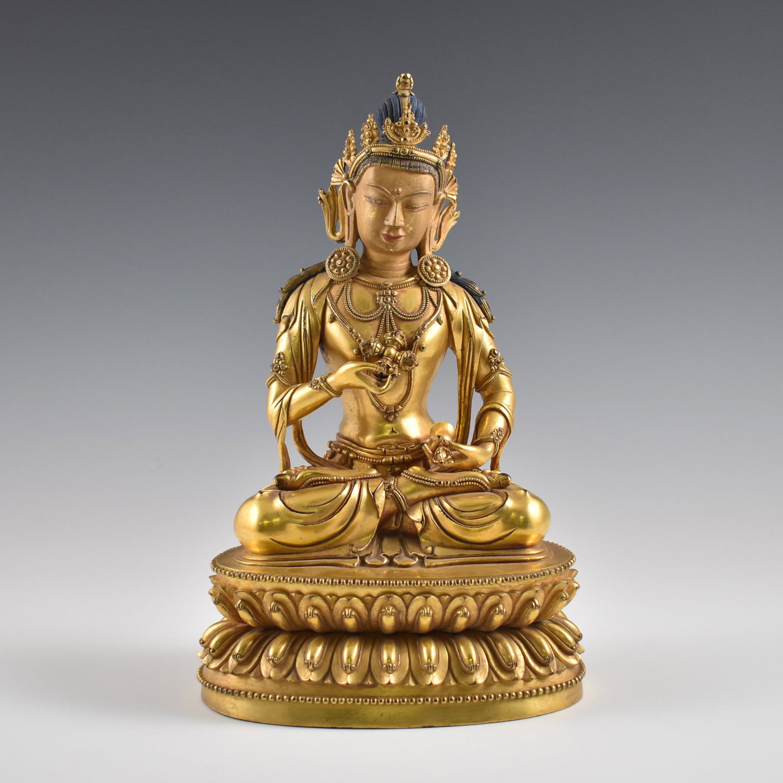 MING GILT BRONZE BUDDHA OF VAJRAPANI CHITTA: Dimensions: 12-1/8" H Chinese Tibetan Ming Dynasty gilt bronze Buddha figure of Vajrapani Chitta, Vajra-scepter Holder, from the Sarvadurgati Parishodhana Tantra. In vajra posture with the right hand 