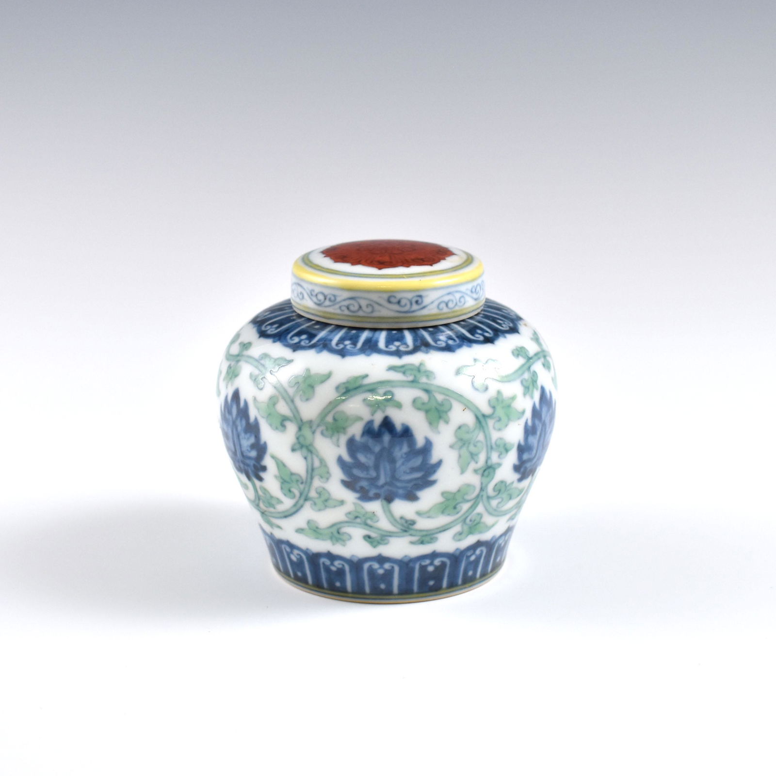 Ming Doucai floral lidded jar: Dimensions: 3-1/8" H x 3-3/8" W Chinese Ming Dynasty Period, Doucai floral lidded jar. Potted with a large cylinder vessel, jar shape, having thick body, sturdily potted in slight oval belly, heavy on