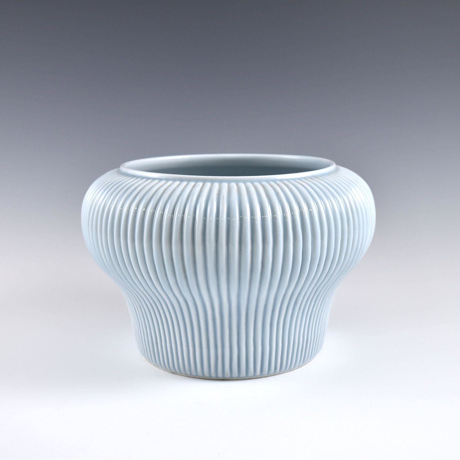 Ming Tianqing (Sky Blue) glazed ribbed jar: Dimensions: 7" H x 10-3/8" Dia. PROVENANCE: From Private estate collections of Jullias Phillips (1923 - 2017), Marietta, Georgia. When WWII started, Jullias worked at the Charleston Navy Yard helping 