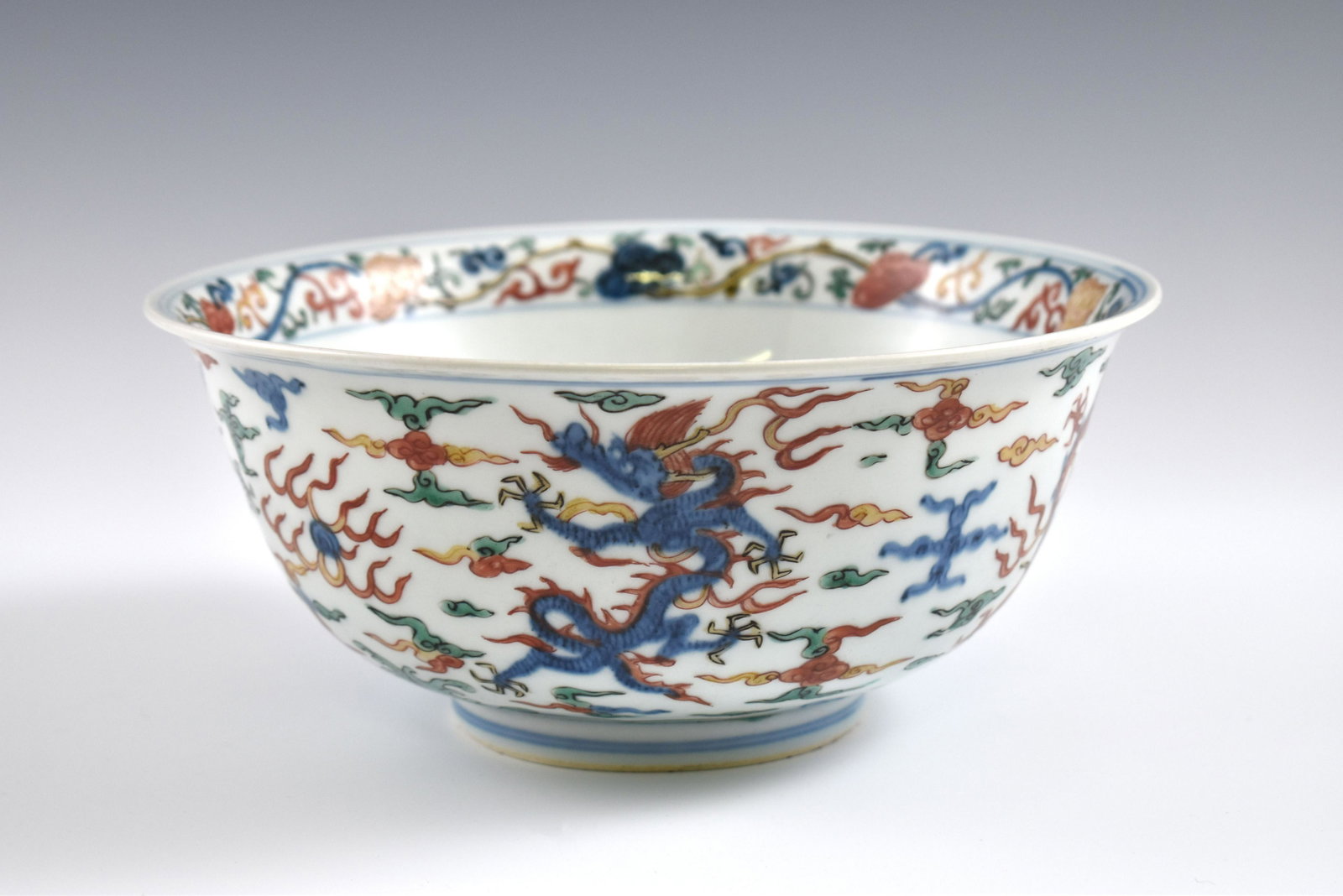 Ming Jiajing Wucai dragon bowl: Dimensions: 4-1/8" H x 9-3/8" Dia. Chinese Ming Dynasty Period, Jiajing Wucai dragon bowl. Potted with a shallow body, slight deep, thick and bulbous body, with angled cavetto elevated the steep sides