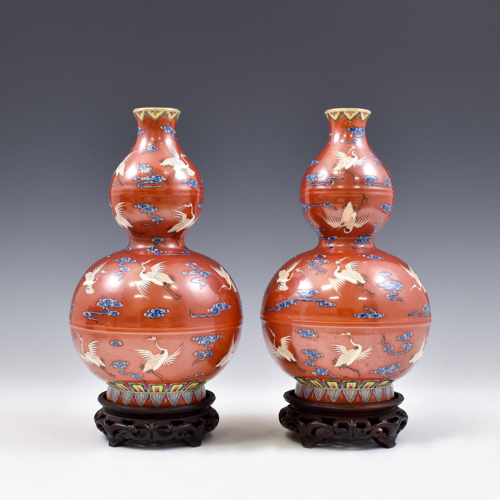 PAIR OF QIANLONG RUBY RED DOUBLE GOURD VASES: Dimensions: 9-7/8" H x 5-1/2" Dia. (each) Stand: 1-1/2" H Chinese Qing Dynasty Period, Pair Qianlong double gourd crane ruby-red porcelain vases. Finest porcelain potted in double gourd resemblance, b