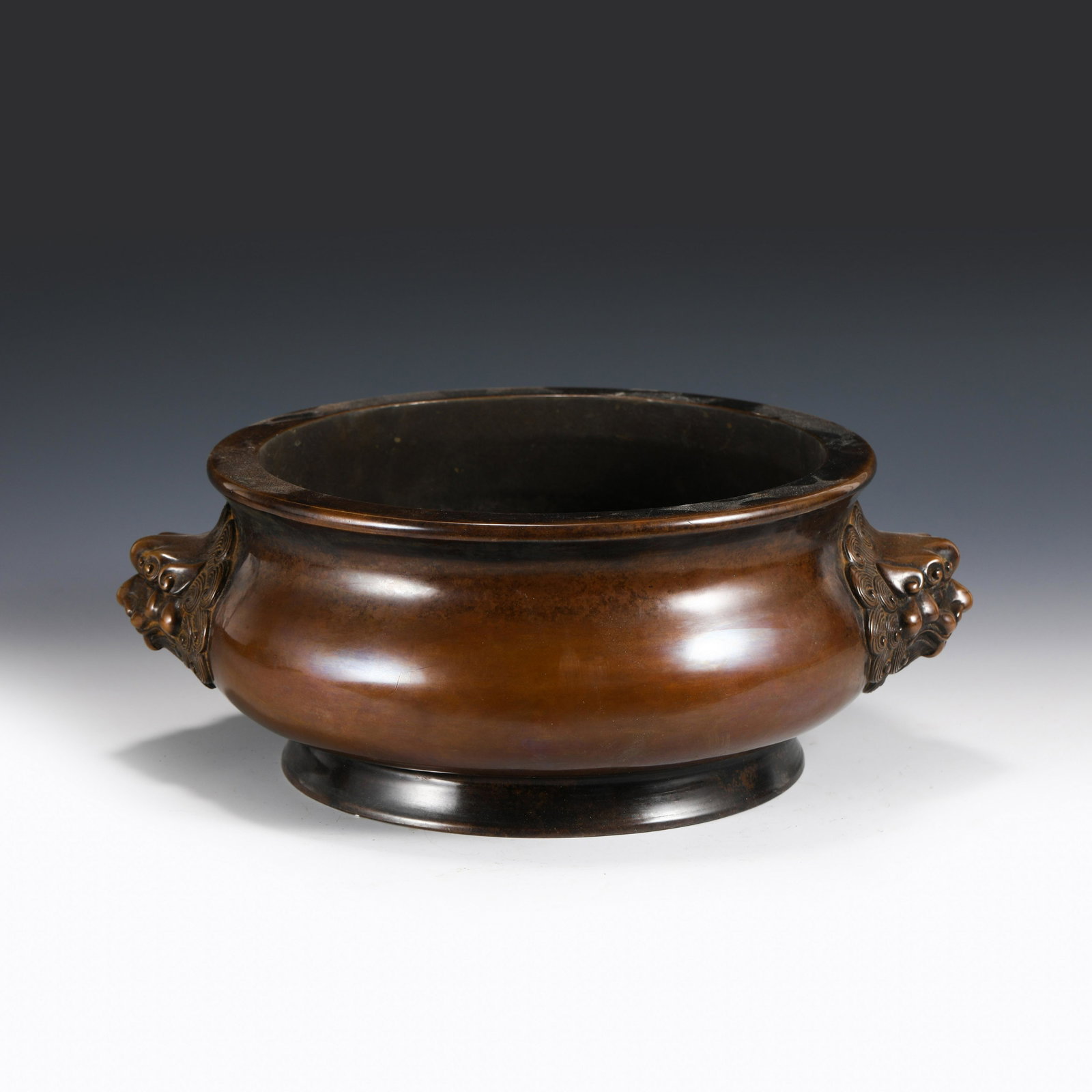 XUANDE LION EARS BRONZE CENSER: Dimensions (cm): Diameter: 27 Height: 13 Weight (gram): 11550 Chinese Ming Dynasty Period Lion ears bronze Censer. This bonze incense burner has a round flaring mouth lip, flanked mythical beast head 