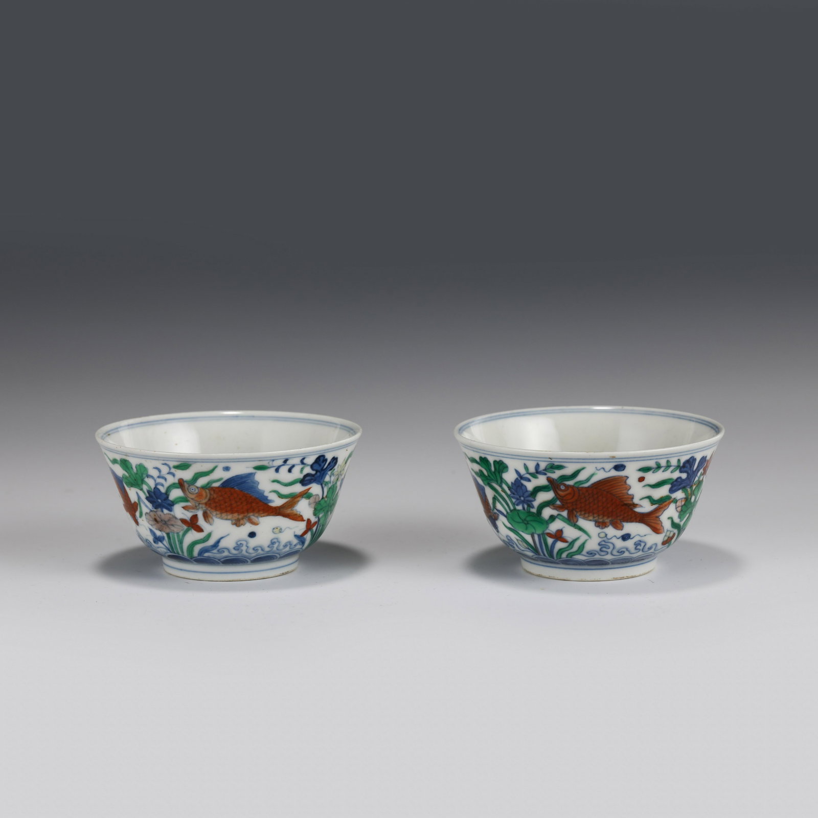 PAIR OF CHENGHUA DOUCAI SMALL CUPS: Dimensions (cm): Height: 5 Diameter: 9 Pair of Chinese Ming Dynasty Period Doucai Small porcelain Cups. Potted with a shallow body, slight deep, thick and small bulbous body, with angled cavetto eleva