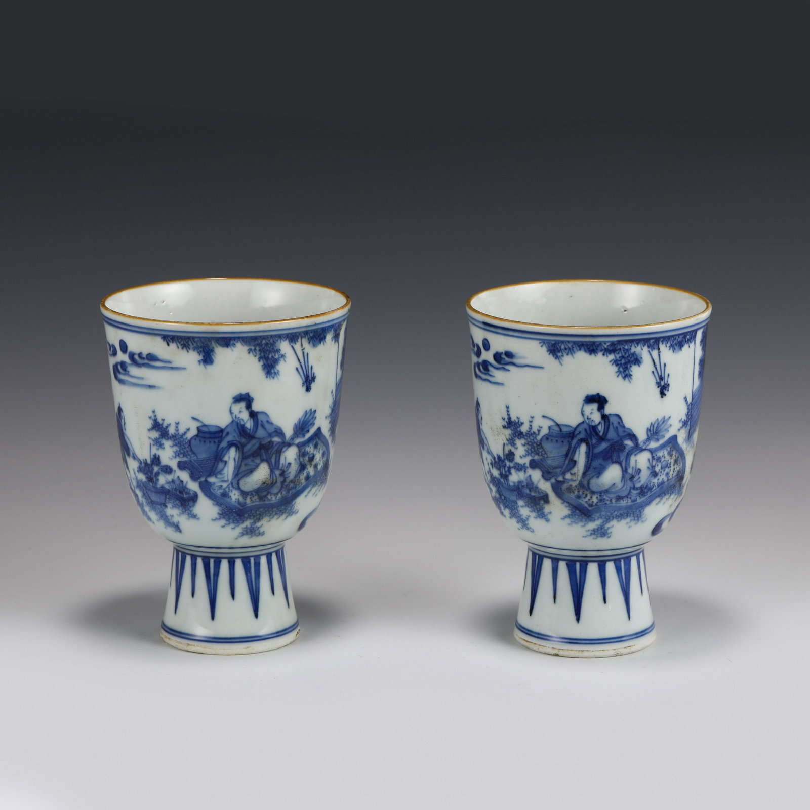 PAIR BLUE & WHITE HIGH STEM CUPS: Dimensions (cm): Height: 15 Diameter: 11.5 Pair of Chinese Ming Dynasty Period Blue & white high stem cups. Potted with a shallow body, deep, thick and small bulbous body, with angled cavetto elevated