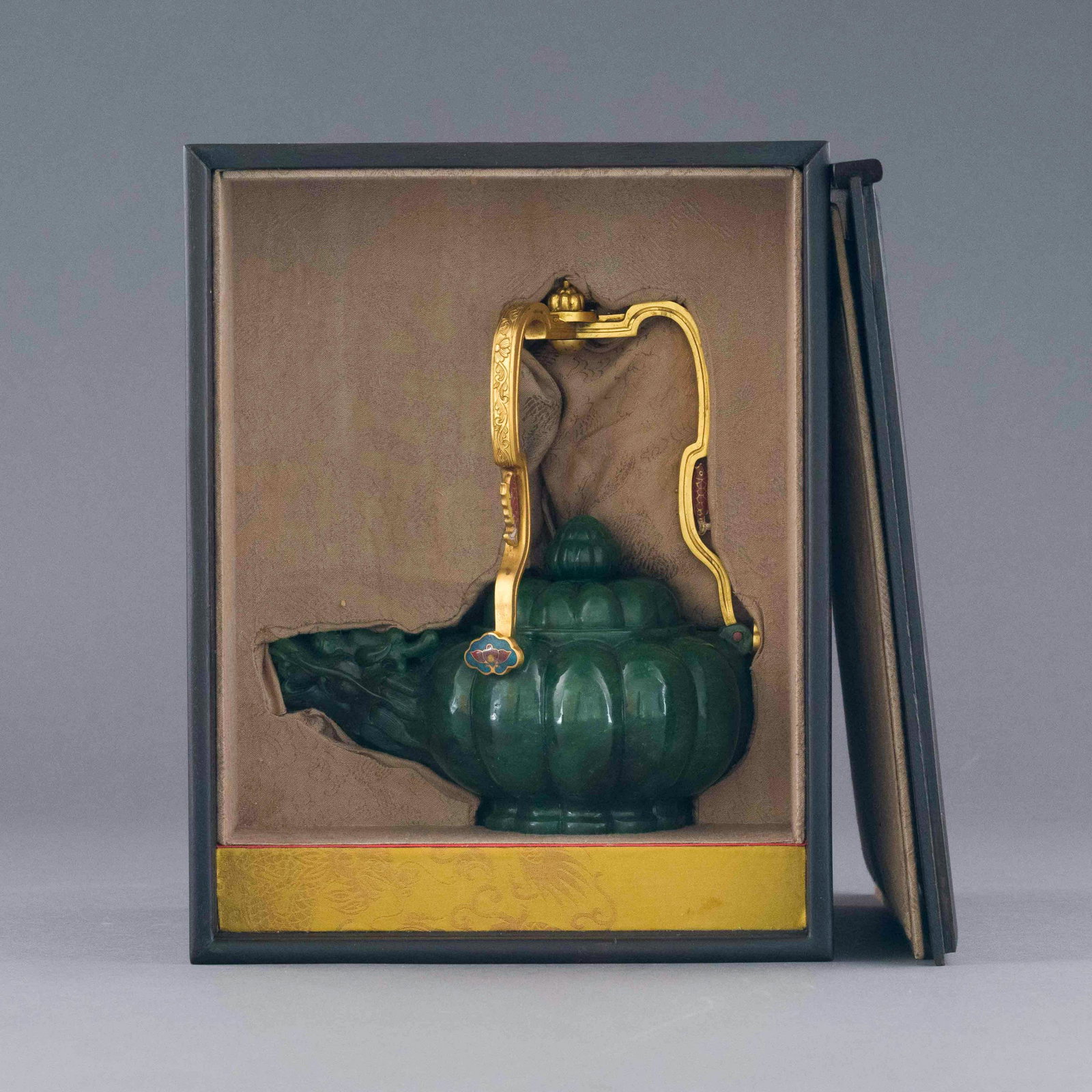GREEN JADE GILT BRONZE HANDLE TEA POT IN BOX: Dimensions: 11in H x 8.75in W x 6.875in D Stunning, Chinese 15th Century Ming Dynasty Period, green jade gilt bronze handle tea pot. Impeccable Spinach green jade teapot in the shape of a Plum, with g