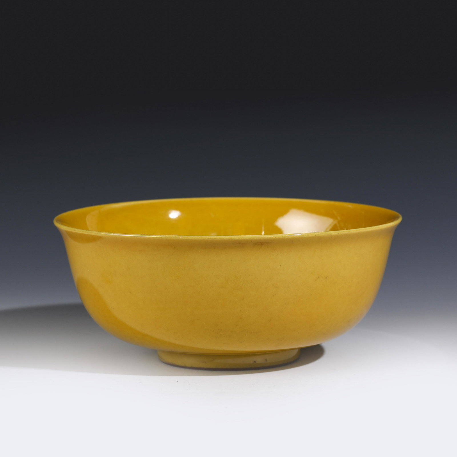 MING YELLOW GLAZED LARGE BOWL: Dimensions (cm): Height: 9 Diameter: 20 Chinese Qing Dynasty Period Yellow glazed Large Bowl. Potted with a shallow body, slight deep, thick and large bulbous body, with angled cavetto elevated the st
