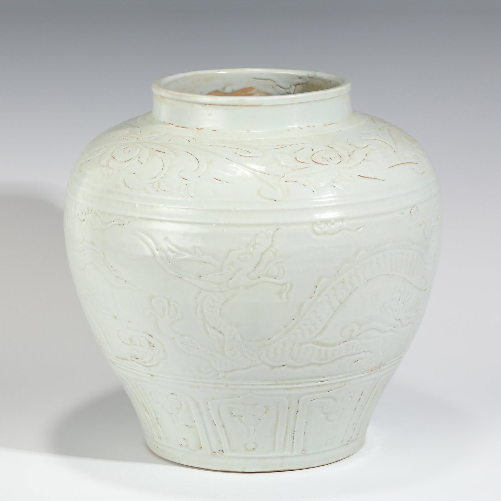EARLY MING BLANC DE CHINE PORCELAIN JAR: Dimensions: Height: 32 cm, Diam.: 30 cm Chinese Early Ming Dynasty Blanc De Chine Dragon Motif Porcelain Jar. This porcelain has an round open mouth with a slightly out-turned lip, short thick neck le