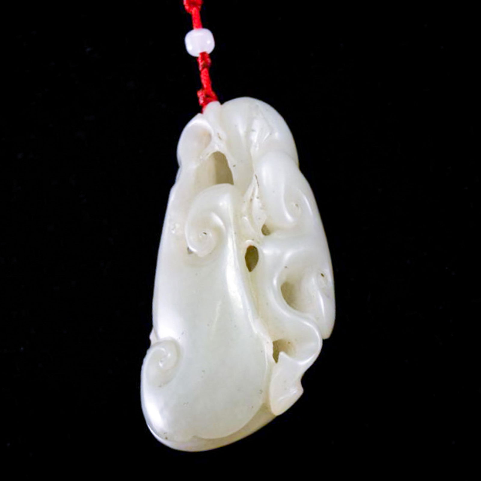 FU-BAT AND LINGZHI MUSHROOM JADE PENDANT: Dimensions: 76.47mm H x 41.51mm W Weight: 115.30 grams The Chinese nephrite jade carved unto a Fu-Bat over Lingzhi sacred fungus. The jade shows grayish crème iridescent with moist milky appearance.
