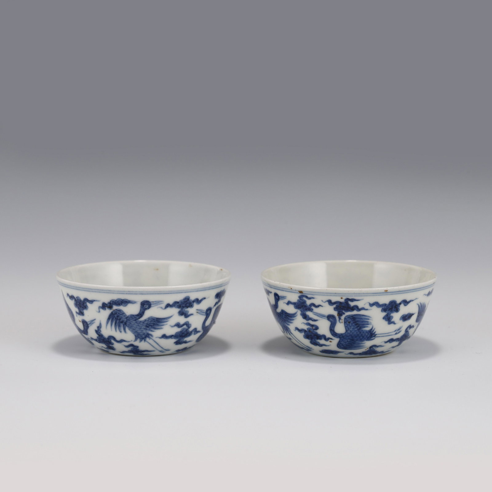 PAIR CHENGHUA BLUE & WHITE CRANE MOTIF PORCELAIN BOWLS: Dimensions: Height: 3.5cm, Diam: 8cm Pair of Chinese Ming Dynasty Period, Chenghua Blue and white cranes motif porcelain bowls. Potted with a shallow body, has an open mouth, deep arced body, and rais