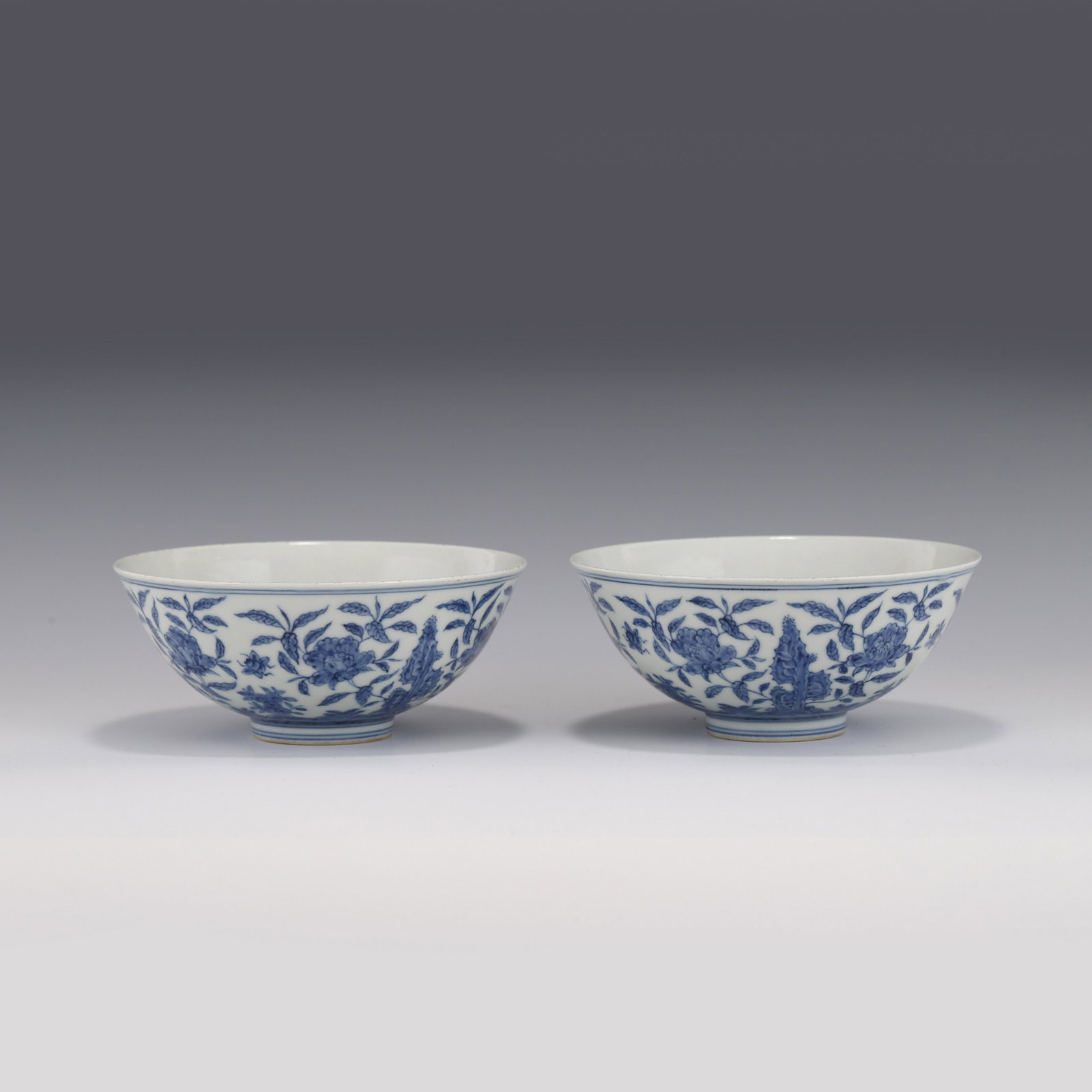 PAIR BLUE & WHITE PEONY & ROCKWORK PORCELAIN BOWLS: Dimensions: Height: 6.7cm, Diam: 15.9cm Pair of Chinese Ming Dynasty Period, Chenghua Blue and white peony porcelain bowls. Potted with a shallow body, has an open mouth, deep arced body, and raised o