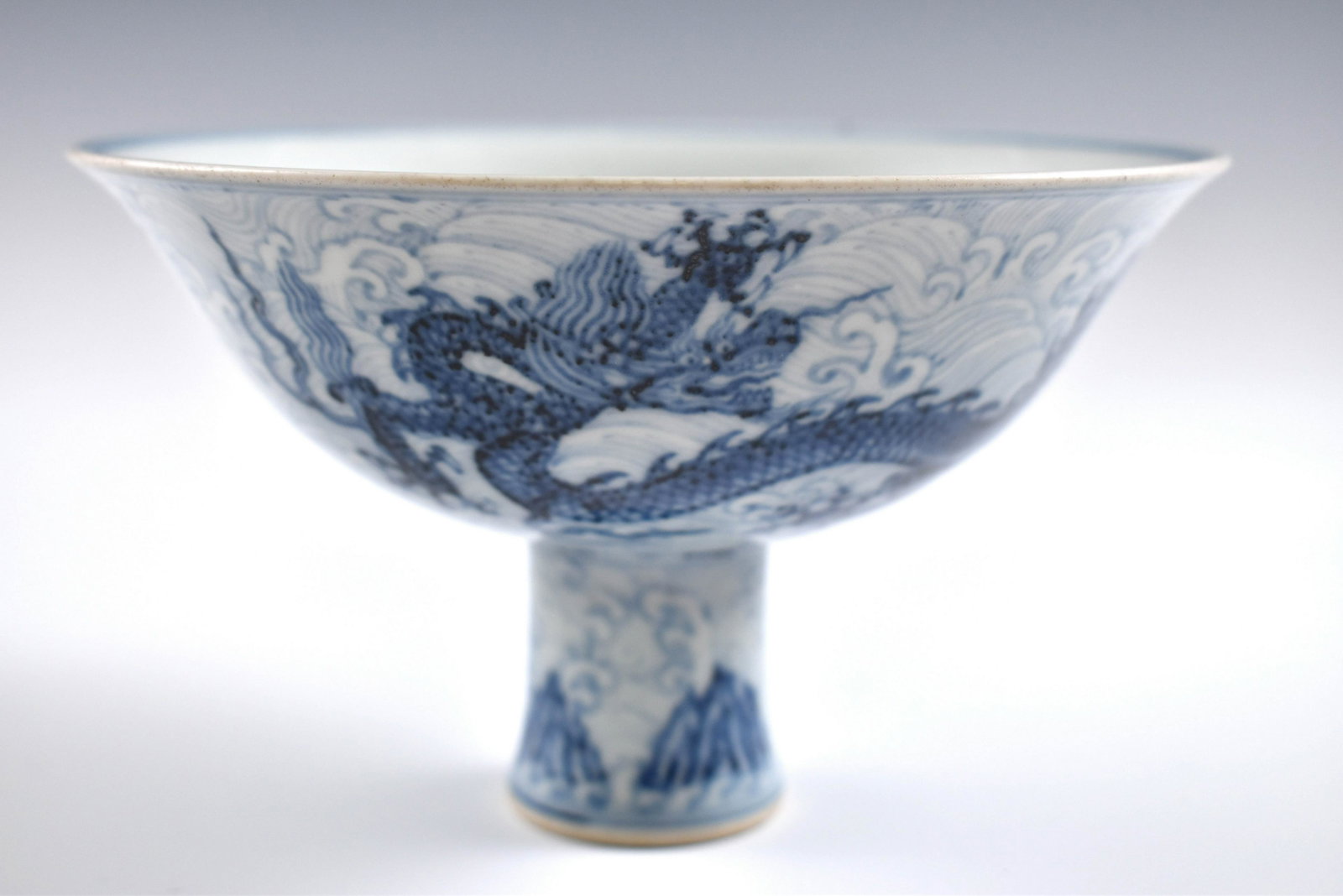 Ming Xuande Blue & white dragon high bowl: Dimensions: 3-3/4" H x 6-5/8" Dia. Chinese Ming Dynasty Period, Xuande Blue & white dragon high bowl. Potted with a shallow body, slight deep, thick and bulbous body, with angled cavetto elevated the 