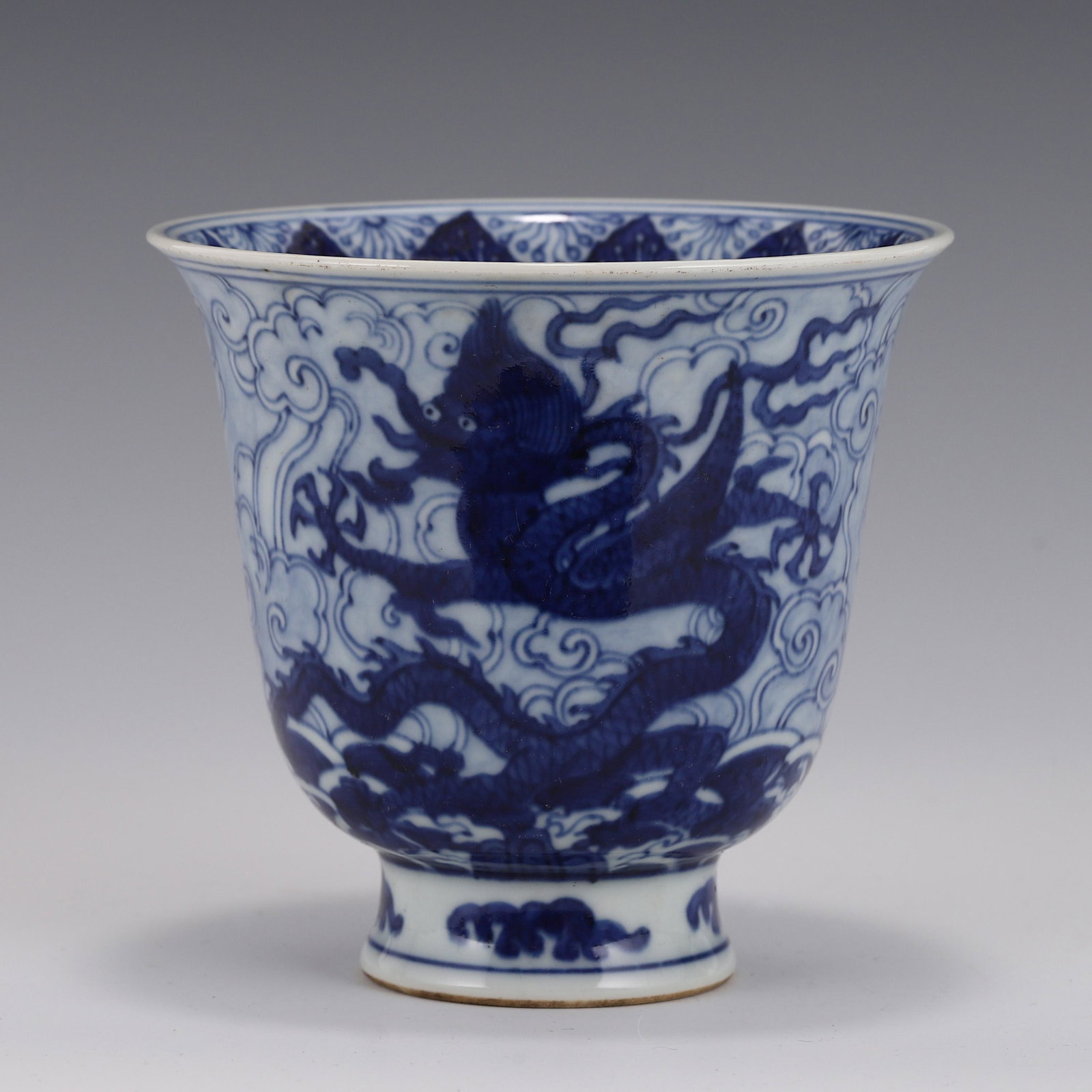BLUE & WHITE DRAGON PORCELAIN WINE CUP: Dimensions: Height: 11.5cm, Diam: 12.5cm Chinese Ming Dynasty Period, Jiajing Blue and white Dragon porcelain wine cup. The Porcelain potted in wine cup, of inverted bell form, deep curved side, bulbo