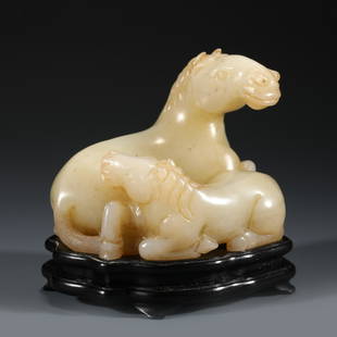 CHINESE WHITE JADE DOUBLE HORSES ON STAND: Dimensions: Length: 9.5cm, Width: 7cm, Height: 7.5cm Chinese White Jade Double Horse Statue On Carved Hardwood Stand. Jade carved resembling a horse resting in relaxed position, while head facing righ