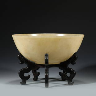 WHITE JADE BOWL ON BOWL: Dimensions: Width: 20.8cm, Height: 7.7cm Chinese Qing Dynasty White Jade Bowl on Carved Hardwood Stand. The bowl has an open mouth, deep arced body, and short ring foot. Elegantly and smooth