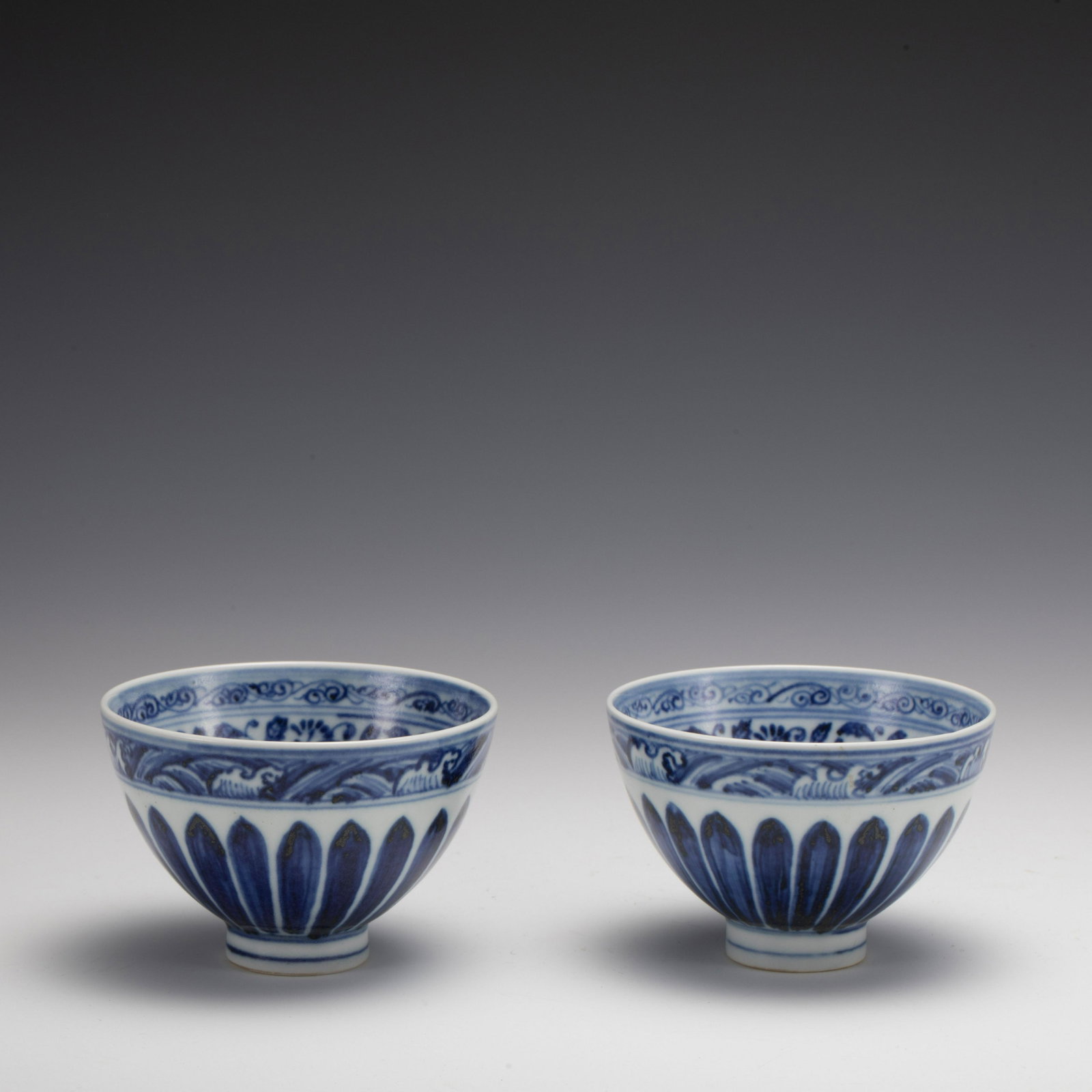 MING YONGLE BLUE & WHITE BOWLS: Dimensions: Width: 10.5 cm x Heigth: 6.7 cm Pair of Chinese Ming Dynasty YongLe Blue and White Porcelain Bowls. The porcelain potted in a shallow, slight deep, flaring rim with close mouth rim, raised