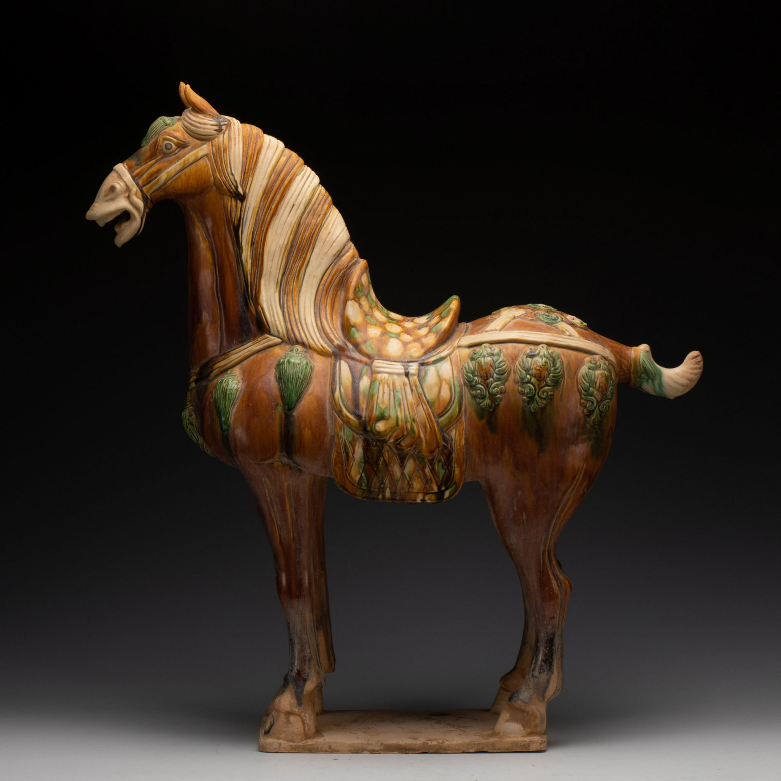 TANG SANCAI HORSE STATUE: Dimensions: Length: 67 cm x Width: 23 cm x Heigth: 71 cm Chinese Tang Sancai Horse Statue. Potted in horse in standing relaxing position on its four legs. forward head, its open mouth showing teeth, a