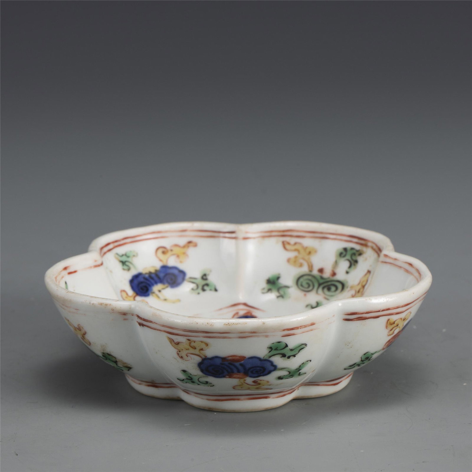 MING LONGQING WUCAI RUYI BOWL: Dimensions: Width: 11.5cm, Height: 3.5cm. Chinese Ming Dynasty LongQing Wucai Ruyi Porcelain Bowl. Potted with a shallow body, slight deep, thick and flori form body, with angled cavetto elevated the 