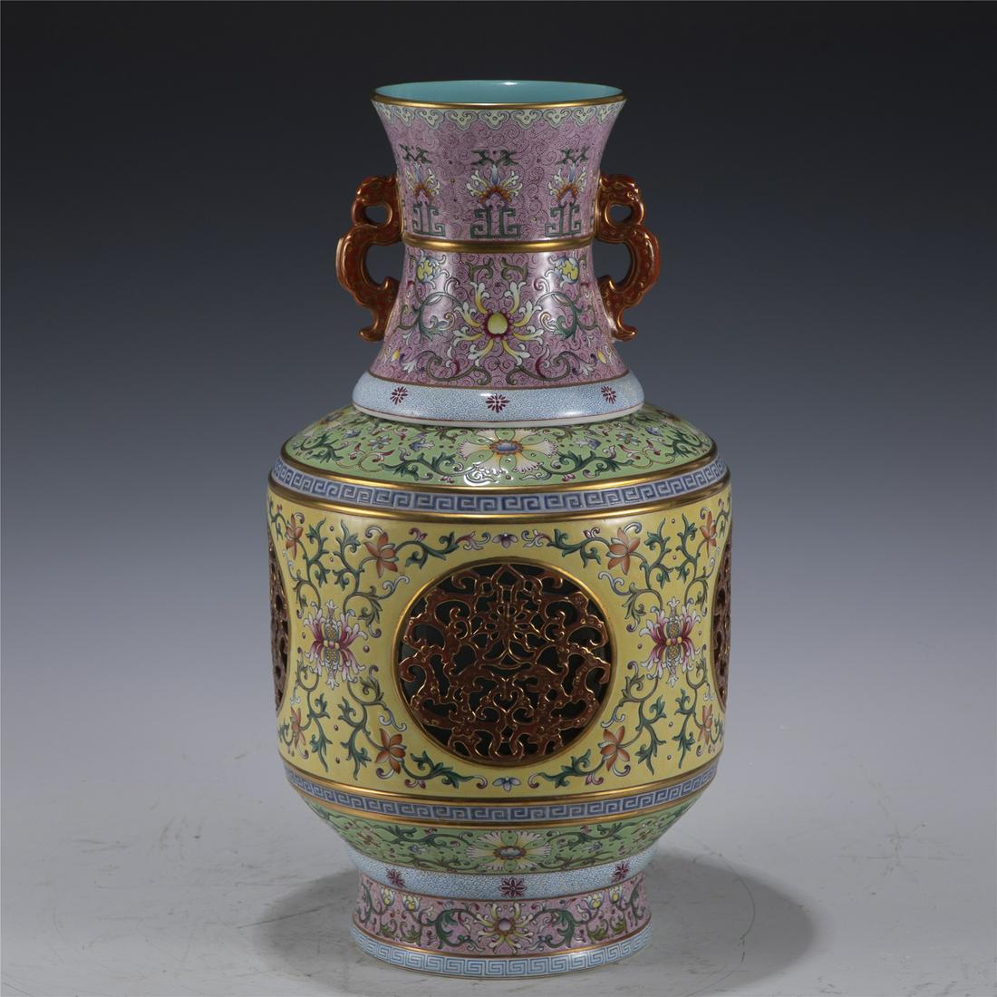 QING QIANLONG FAMILLE ROSE LOTUS GOLD PAINTED PORCELAIN ROTATING HEART BOTTLE. : Dimensions: Length: 22.2 cm, Width: 22.2 cm, Height: 41.2 cm Chinese Qing Dynasty Qianlong Famille Rose Lotus Gold Painted Porcelain Rotating Heart Bottle. The vase potted in a amphora shaped vase, la