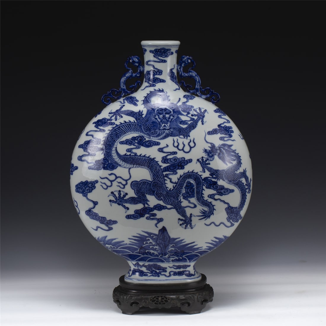 QING QIANLONG BLUE & WHITE MOON VASE: Dimensions: Length: 35.2 cm, Width: 20 cm, Height: 50.5 cm Chinese Qing Dynasty Qianlong Blue and White Porcelain Moon Vase On Carved Hardwood Stand. Potted in moon vase, thick and tall, globular moon
