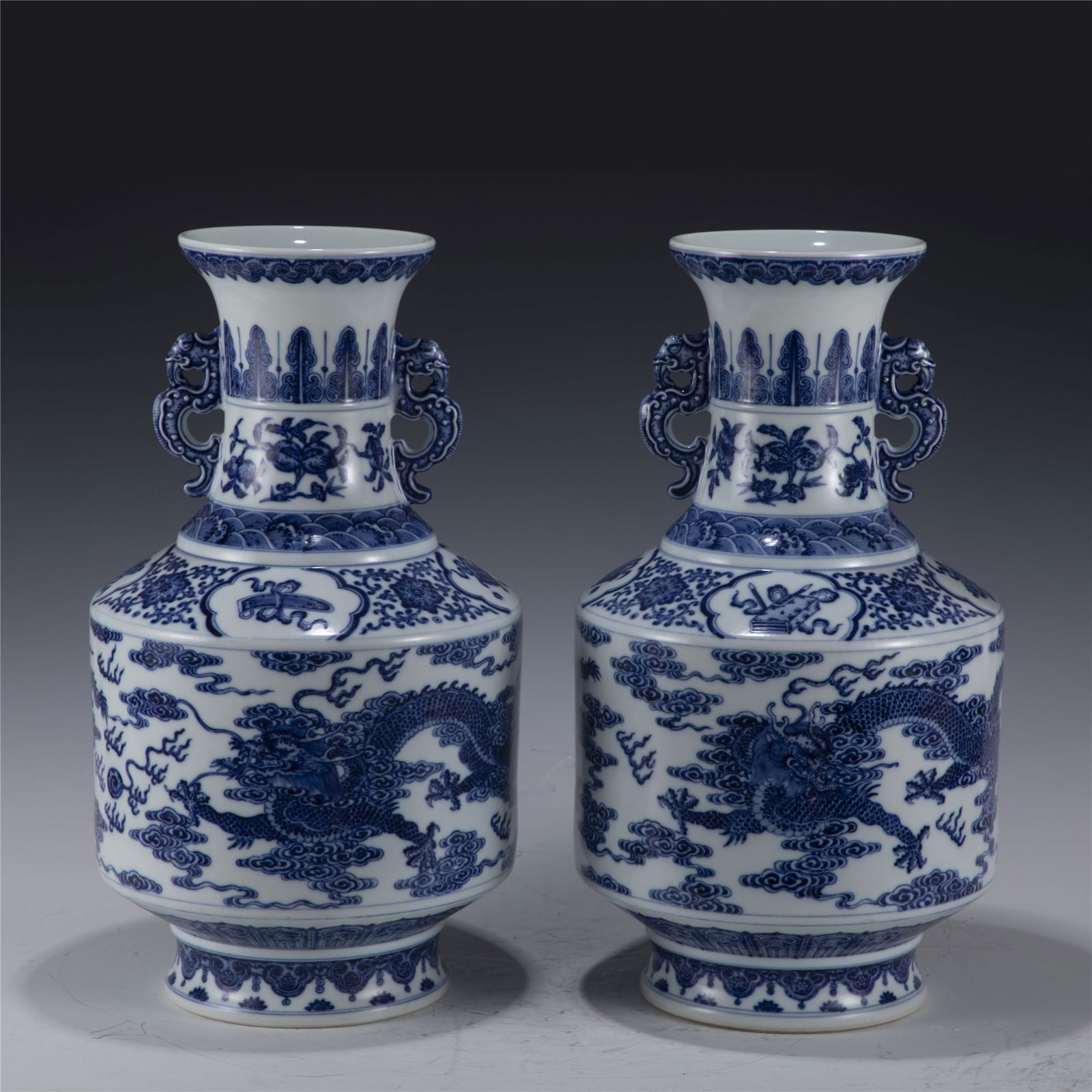 PAIR OF QING QIANLONG BLUE AND WHITE DRAGON VASE: Dimensions: Length: 23 cm, Width: 23 cm, Height: 41.5 cm Pair of Chinese Qing Dynasty Qianlong Blue and White Dragon Porcelain Bottle Vase. The vases potted in a amphora shaped vase, large, thick and