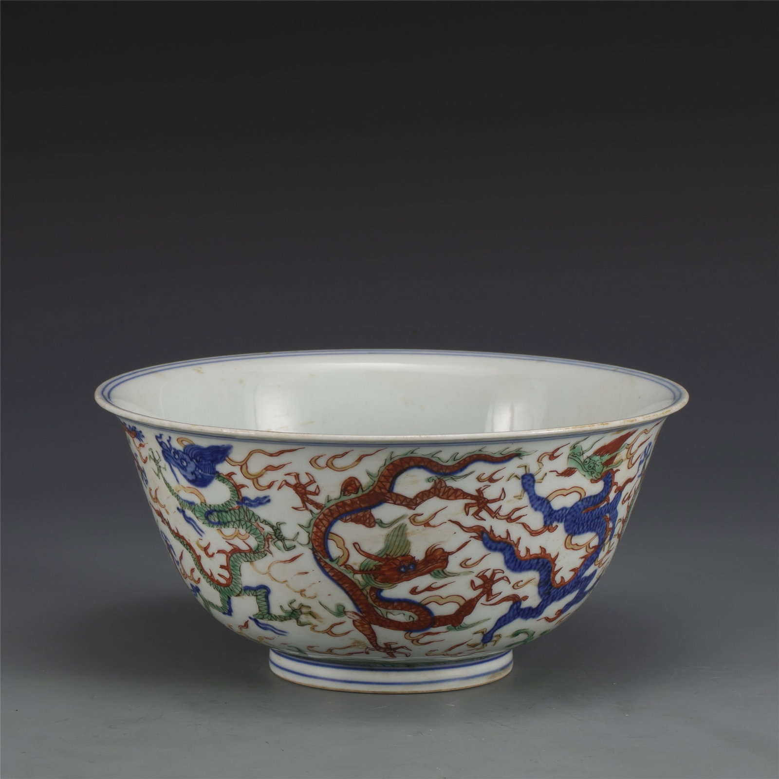 MING JIAJING WUCAI DRAGON BOWL: Dimensions: Width: 24cm, Height: 11.5cm. Chinese Ming Dynasty Jiajing Wucai Dragon Porcelain Bowls. The porcelain potted in a shallow, slight deep, round close mouth rim, raised on ring foot base. Han
