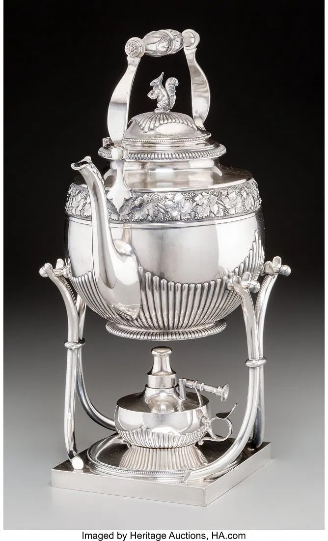 A KOCH & BERGFELD SILVER HOT WATER KETTLE ON STA