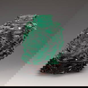 MALACHITE - CARVED ORNAMENT: Dimensions: L. 13 cm. W. 9 cm. H. 19 cm. Weight 1825 grams. This is a malachite - carved ornament. Malachite is a copper - containing carbonate mineral, named for its color resembling a peacock's feat