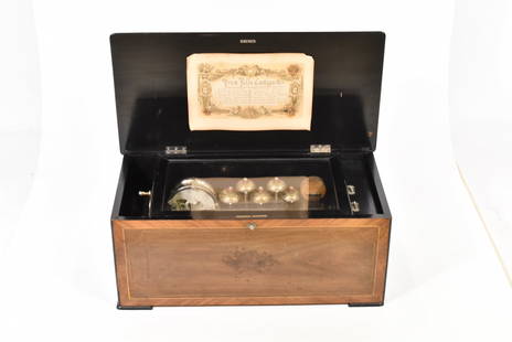 SWISS CYLINDRICAL MUSIC BOX WITH BELLS AND DRUM: Mahogany box with cherry lid containing inlaid wood designs. Mechanical music cylinder plays six old world tunes. Six bells, one hundred notes from cylinder, brass snare drum with nine beaters measure