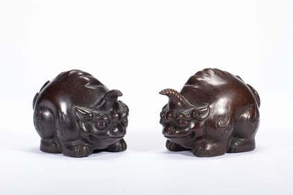 A PAIR OF COPPER BEAST ORNAMENTS