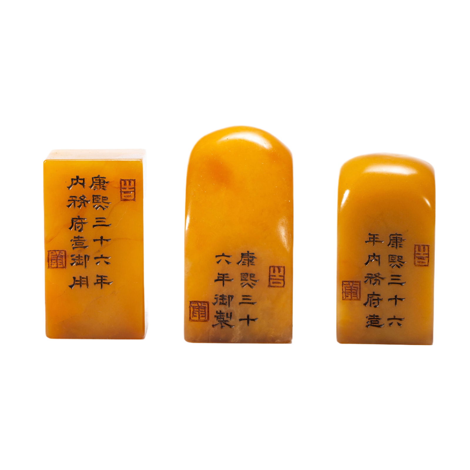 THREE EXQUISITE YELLOW SEAL STONES: Dimensions: L. 3 cm. W. 3 cm. H. 5.5 cm. Weight 390 grams. These are three seal stones. They are in a rectangular shape with smooth surfaces. The stones are a rich, warm yellow color, giving them an e