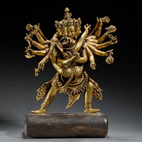 GILT BRONZE MULTI-ARMED DEITY STATUE ON WOODEN BASE