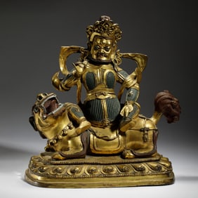 GILT BRONZE STATUE OF VAISHRAVANA (KUBERA) RIDING A LION