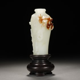 WHITE JADE VASE WITH BROWNISH - RED MARKINGS ON DARK WOODEN BASE