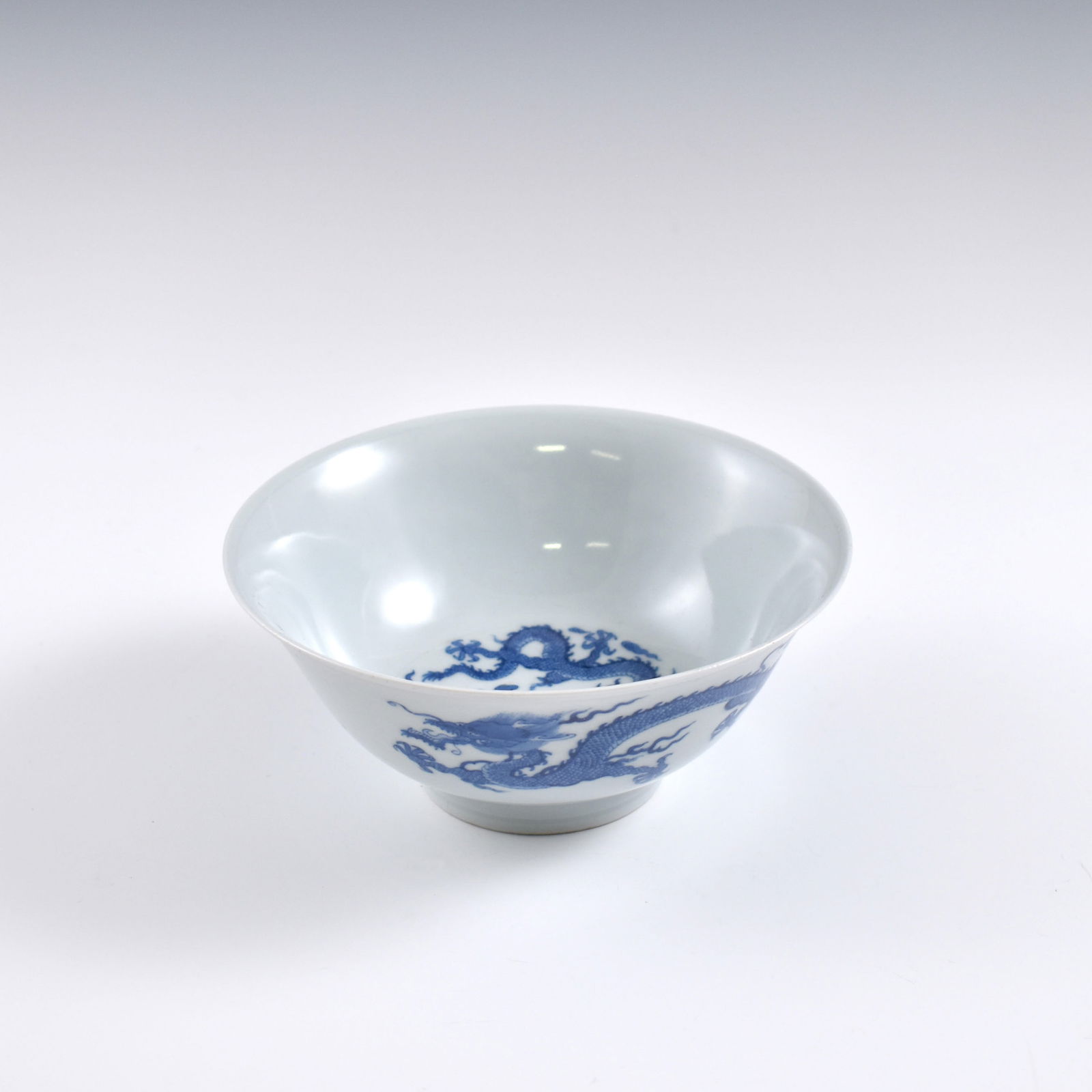 Kangxi Blue & white dragon porcelain bowl: Dimensions: 3-1/4" H x 7-3/8" Dia. Chinese Qing Dynasty Period, Blue & white dragon porcelain bowl. Potted with a shallow body, slight deep, thick and bulbous body, with angled cavetto elevated the st