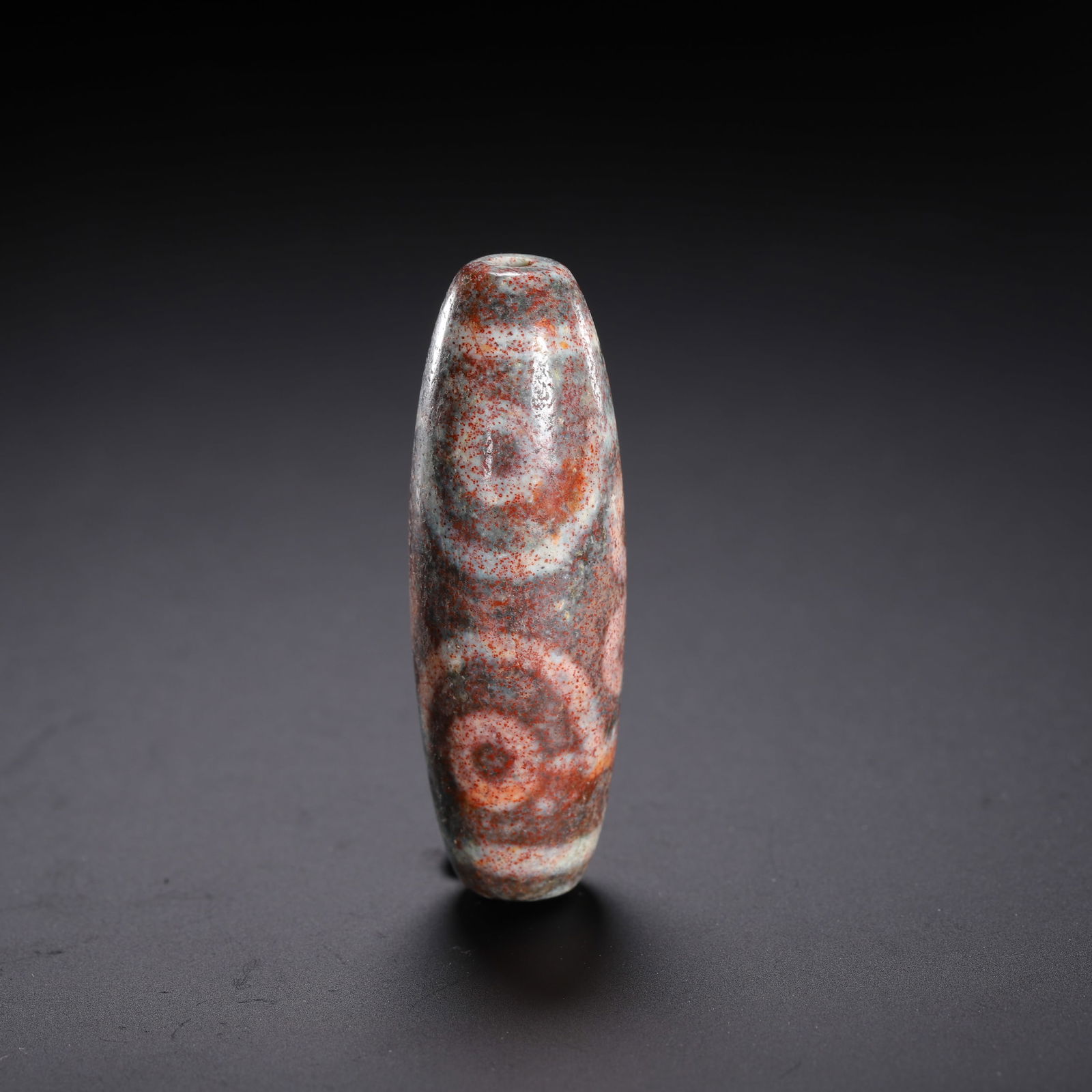 Chinese Tianzhu Bead with Marbled Motifs: Dimensions: L. 5.5 cm. Weight 20 grams. This Chinese Tianzhu bead measures 5.5cm (L) and weighs 20 grams, featuring a marbled palette of russet, cream, and deep gray with organic circular motifs. A re