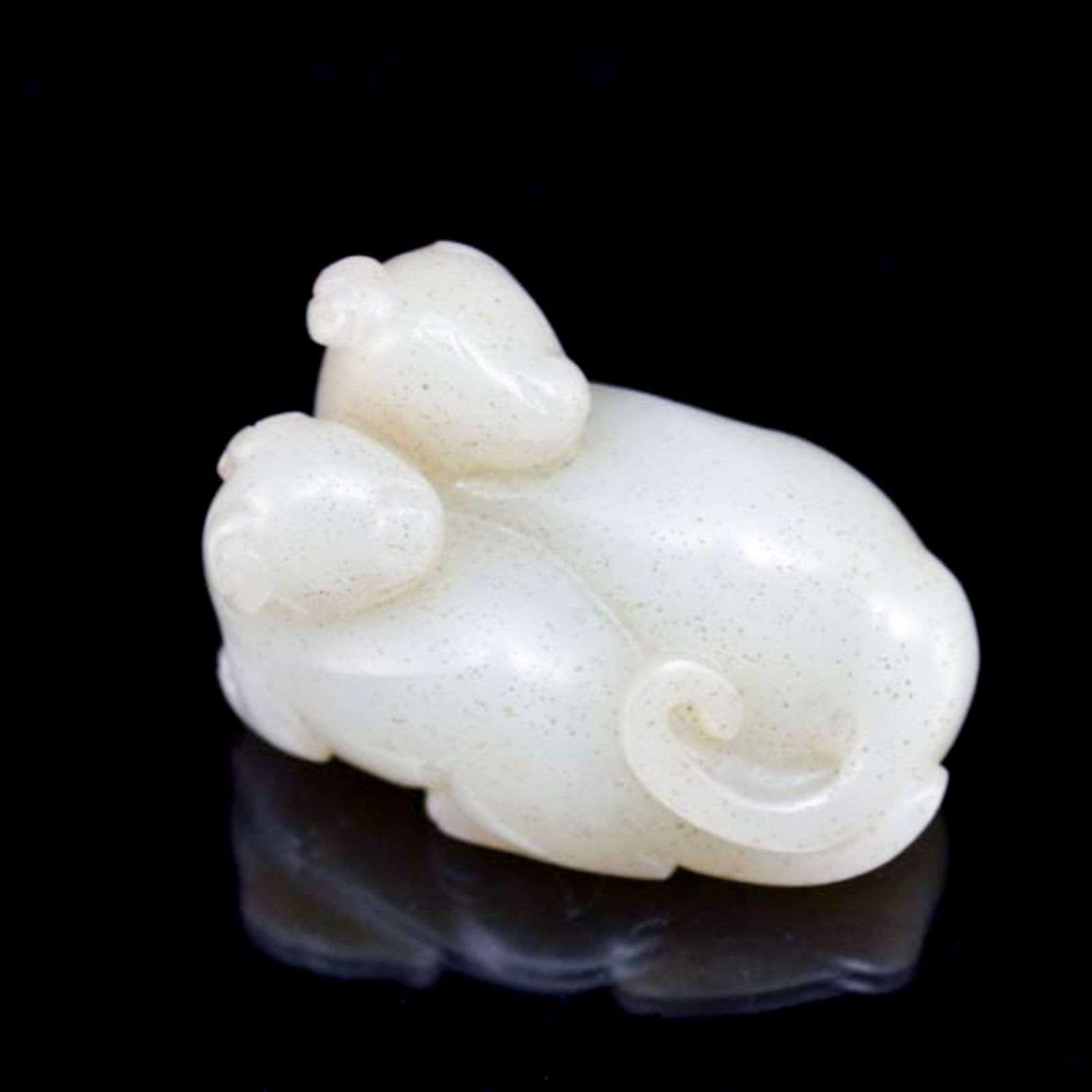 FINE CARVED WHITE JADE OF TWO FERRETS: Dimensions (mm): 31.75mm H x 50.8mm W Weight: 68.9g Fine carved Chinese nephrite jade recumbent pair of Ferrets, both body adhere to each, facing toward its hip, with the tail curled one to another