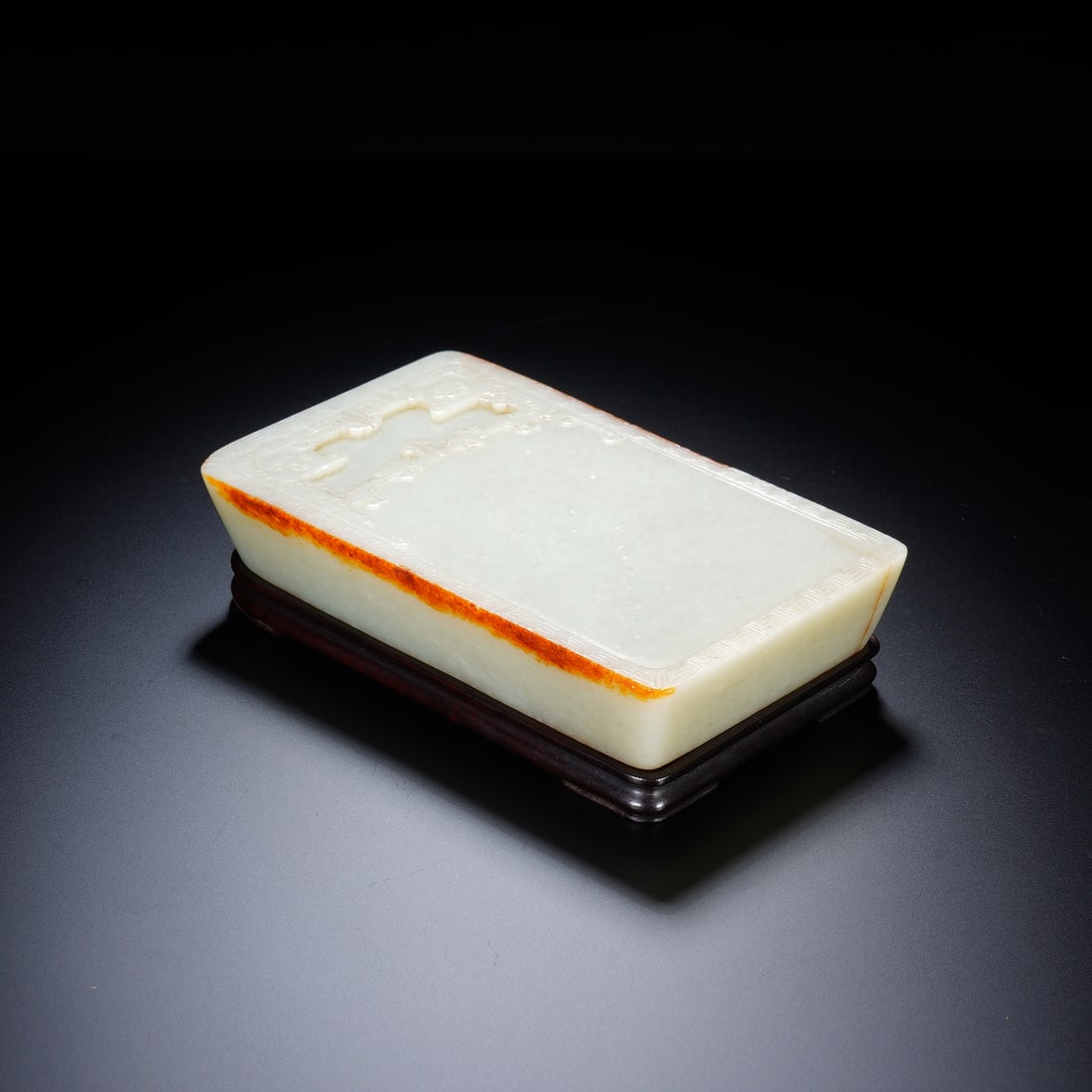 CHINESE WHITE JADE INKSTONE: Dimensions: 13x8.5x3.5 cm. Weight 607 grams. This elegant Chinese white jade inkstone is carved from a luminous stone with natural russet skin, skillfully retained along the edge to enhance its visual