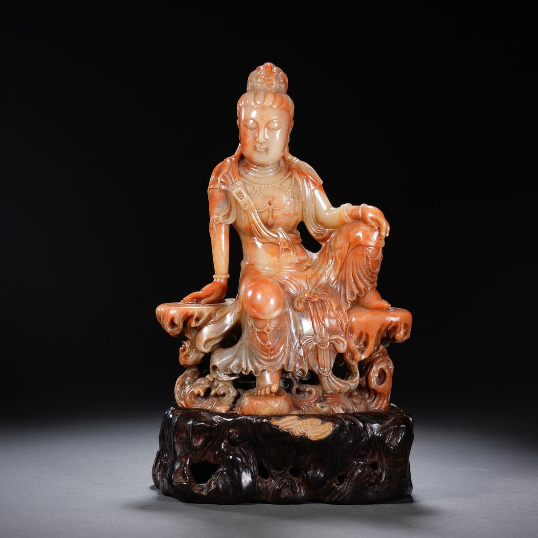 CHINESE SHOUSHAN STONE GUANYIN FIGURE: Dimensions: 14x9x25 cm. Weight 1157 grams. This exquisite Chinese Shoushan stone carving depicts Guanyin in a relaxed ?free and easy? seated posture, resting on a rocky outcrop over swirling waves. Th