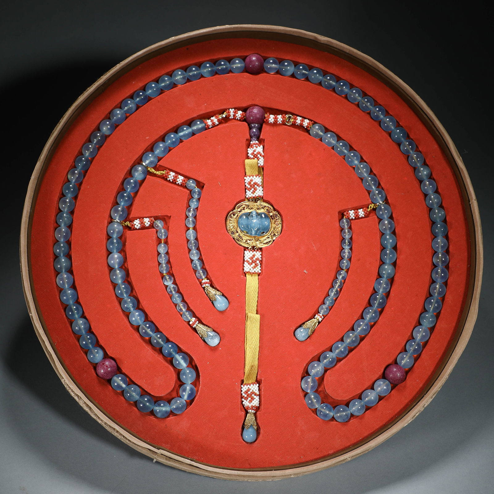 CHINESE AQUAMARINE COURT NECKLACE: Dimensions: Bead diam.1.2 cm. This exquisite Chinese court necklace is composed of smooth, pale aquamarine beads, each measuring 1.2 cm in diameter, accented with vibrant ruby and lapis lazuli spacer