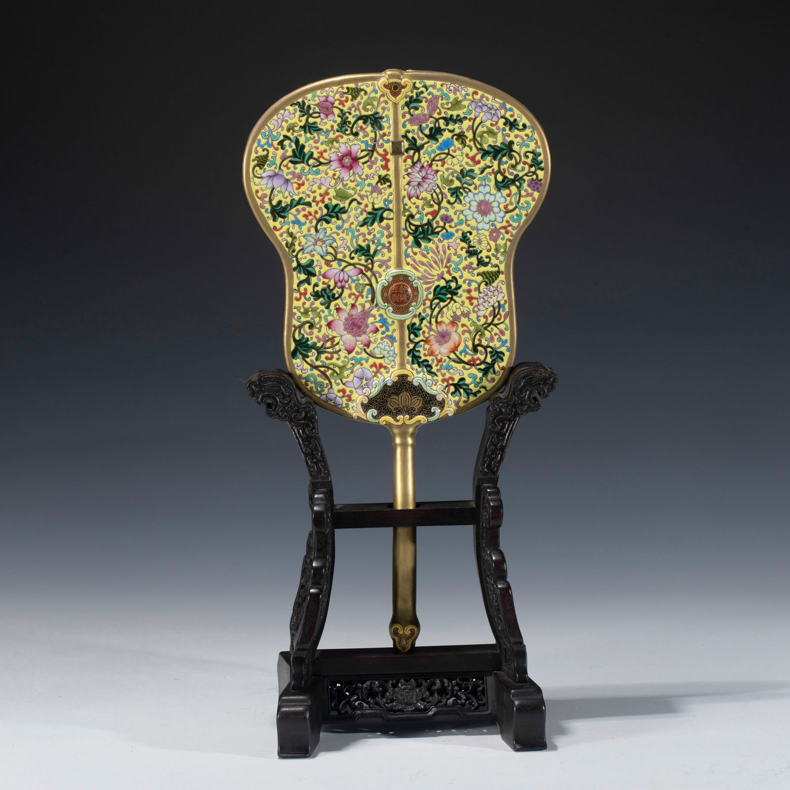 CHINESE QIANLONG FAMILLE ROSE FAN: Dimensions: Length: 22. 7 cm, Width: 2 cm, Heigth: 42. 3 cm Chinese Qianlong Famille Rose Lotus Porcelain Fan Fitted On Hardwood Stand. Potted in fan shaped, two large oval circles are put together wh