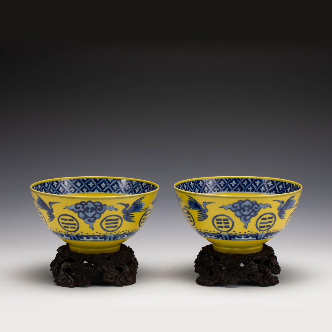 PAIR GUANGXU BLUE & WHITE YELLOW GLAZED BOWLS ON STAND: Measurements: Width: 17.2 cm, Height: 8.5 cm Pair of Chinese Blue White and Yellow Cranes Porcelain Bowls On Carved Hardwood Stands. Potted in a shallow, slight deep, flaring rim with close mouth rim,