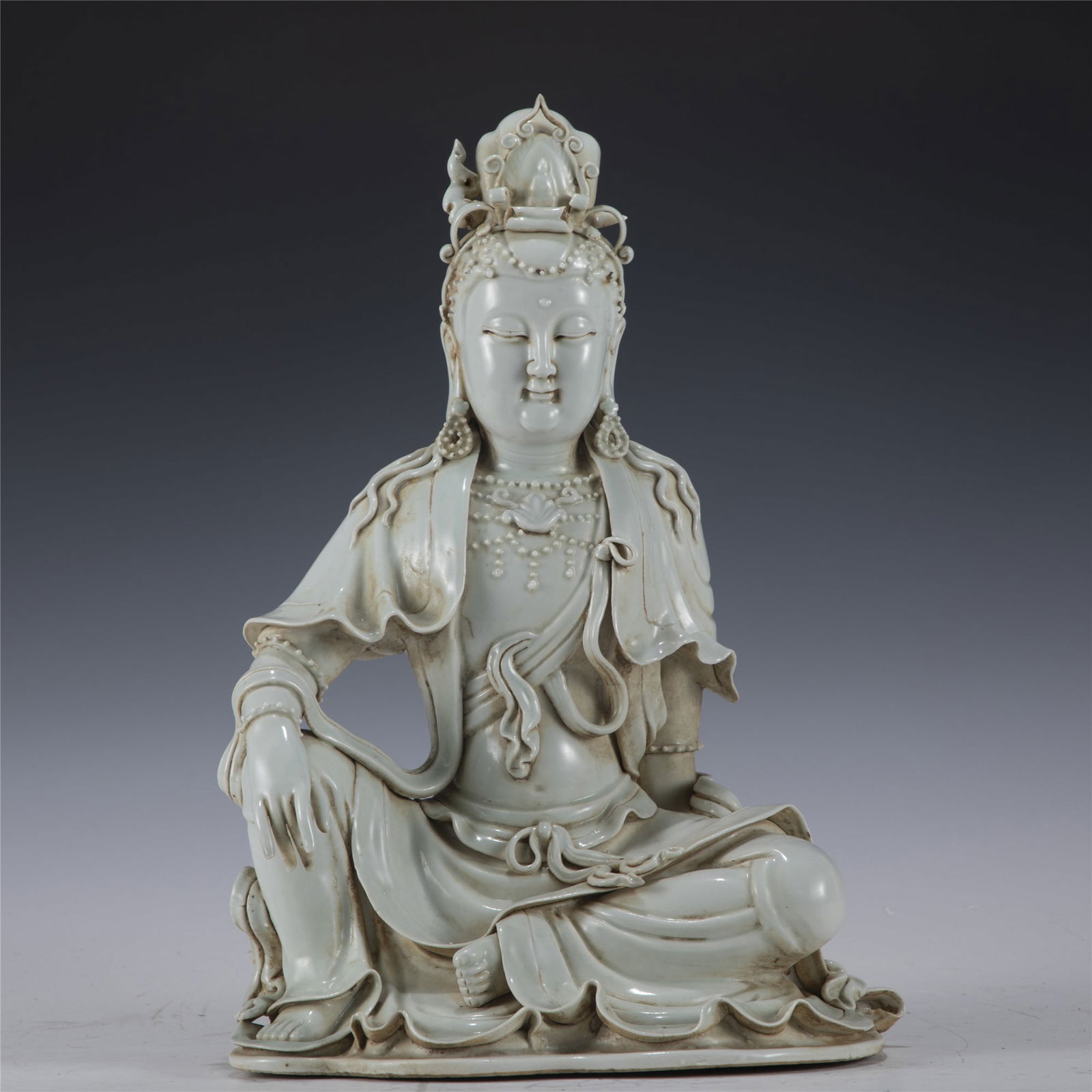 MING WHITE GLAZED AVALOKITESHVARA: Dimensions: Length: 23. 8 cm, Width: 17 cm, Height: 35. 2 cm Chinese Ming Dynasty White Glazed Buddha Avalokiteshvara. This statue of Guanyin potted in a Peaceful face, smiling, beautiful and youthful